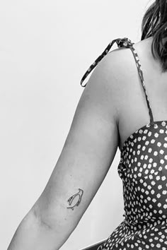 a woman with a tattoo on her left arm