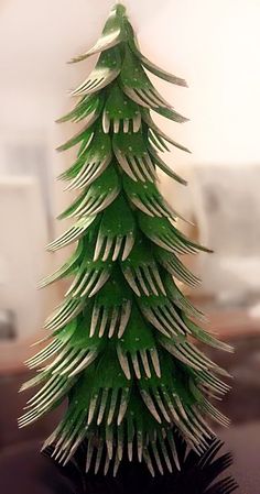 a paper christmas tree sitting on top of a table