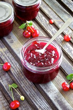 a jar filled with jam sitting on top of a wooden table