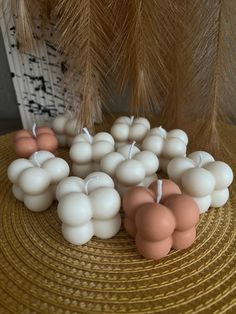 some candles are sitting on a table next to a palm tree and other items in front of it