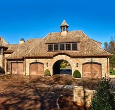 this is an image of a large house in the country side with two garages