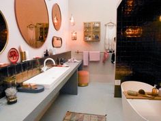 a bathroom with two sinks and mirrors on the wall, along with other decor items