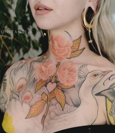 a woman with tattoos on her chest and neck