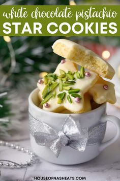 white chocolate pistachio star cookies in a cup on a table with christmas decorations