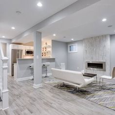 a living room filled with furniture and a fire place next to a stair case in front of a fireplace