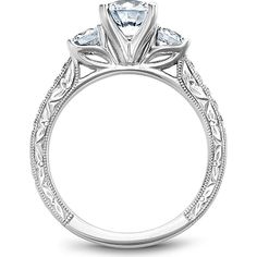 a three stone engagement ring with an intricate design