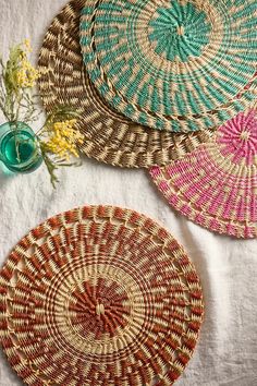 three woven baskets sitting on top of a table