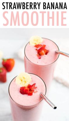 two glasses filled with strawberry banana smoothie on top of a white table next to strawberries