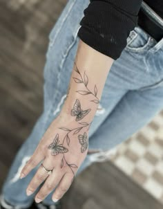 a person with a butterfly tattoo on their hand