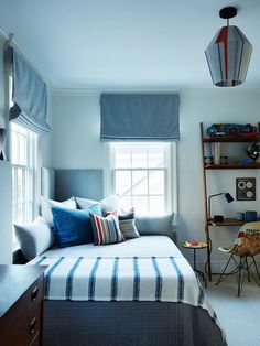 a bedroom with a bed, desk and window