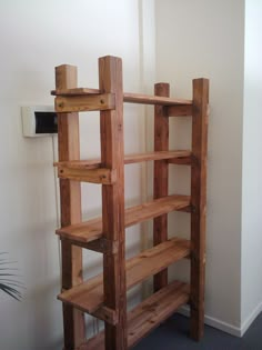 a wooden shelf sitting next to a white wall