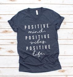 a women's v - neck shirt with the words positive mind positive vibes positive life on it