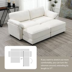 a white couch sitting on top of a hard wood floor