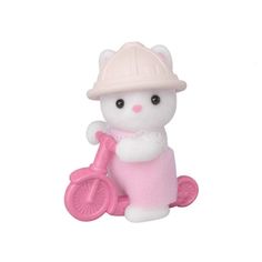 a small white cat with a pink bike on it's back legs and wearing a helmet