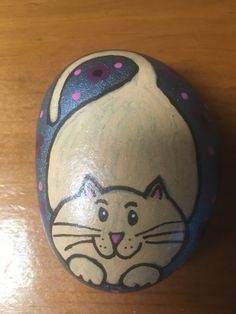 a painted rock with a cat on it