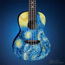 an acoustic guitar with the starry night painting on it's body and neck