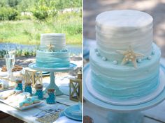 there are two cakes on the table and one is blue with white frosting, while the other has starfish decorations