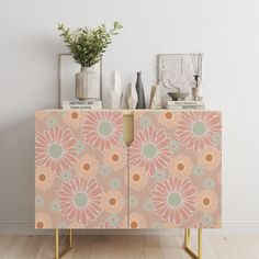 an orange and pink cabinet with flowers on it