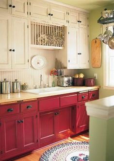 a kitchen with red cabinets and white appliances