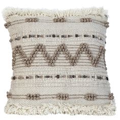 a white and brown pillow with tassels on it