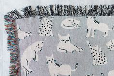 a gray and white rug with horses on it