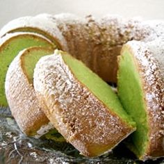 a cake that has been cut in half and is on a plate with some powdered sugar