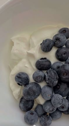 blueberries and yogurt in a bowl with the words blueberries for breakfast