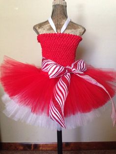 This tutu dress will make the best holiday pictures ever! Perfect for pageants or pictures with Santa! The Candy Cane Princess dress, comes with or without the peppermint candies.  Red glitter tulle is on top of white tulle to create the candy cane effect.  Hello sparkle! The ribbon sash is striped with red and white glitter, in a candy cane pattern, for extra sparkle!  The dress has a ribbon halter or shoulder straps. Spot clean only. Dress Christmas Outfit, Christmas Tutu Dress, Princess Tutu Dresses, Red Tutu, Diy Tutu, Mannequin Art