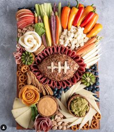 a football themed platter with fruit, vegetables and dips