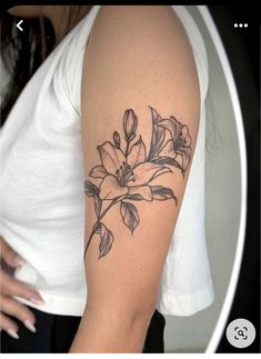 a woman's arm with a flower tattoo on the left side of her arm