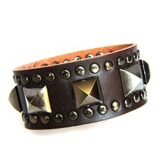 Genuine Leather Vintage style Bracelet that is Super Sexy This bracelet is designed with a 9 1/2 inch length piece of Brown genuine cowhide leather (1 1/4 inch wide) that is given Sexy Style with a center row of Antiqued Gray Pyramid Studs and a border of Rivet Studs.  It is finished with (2) sets of matching snaps for a wearable size variation of 7 1/2" & 8 1/4" Check out the rest of our Bling Collection at our eBay Store...The Lionz Bling. Thick Leather Bracelet, Spiky Bracelet, Punk Bracelets, Spike Bracelet, Diy Leather Bracelet, Hydraulic System, Hydraulic Excavator, Light System, Brown Leather Bracelet