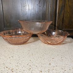 three glass bowls sitting on top of a table