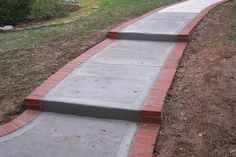 two cement steps leading to a grassy area