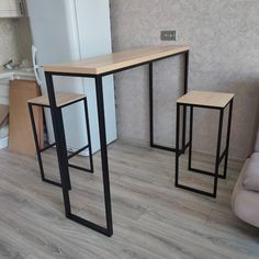 a table and two stools in a room