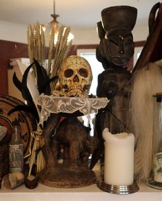 a skull sitting on top of a shelf next to candles