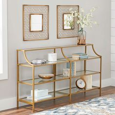 a living room with two mirrors on the wall and a gold bookcase in front of it