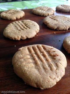 some cookies are on a wooden table and ready to be eaten