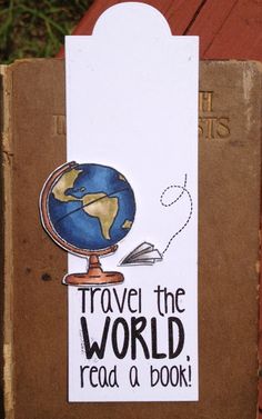 a bookmark with the words travel the world read a book and a globe on it