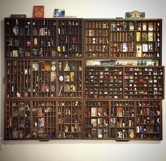 a wooden shelf filled with lots of different types of items on top of each other