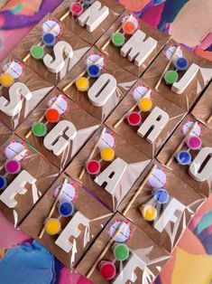 the letters and numbers are made out of brown paper with colorful candies on them