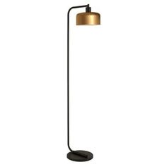 a floor lamp with a black base and a gold shade on the top, in front of a white background