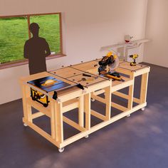 a man standing next to a workbench with tools on it in front of a window