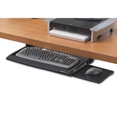 a computer keyboard sitting on top of a wooden desk next to a mouse and printer