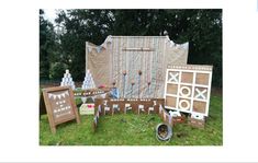 an outdoor party with wooden signs and decorations