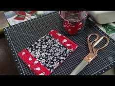 a pair of scissors sitting on top of a cutting board