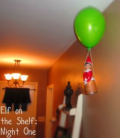 a green balloon is floating in the air