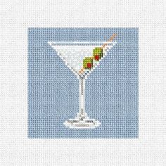 a cross stitch pattern with a martini glass on the side and a straw in it