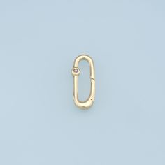 a yellow gold ring with a diamond on the top, against a light blue background