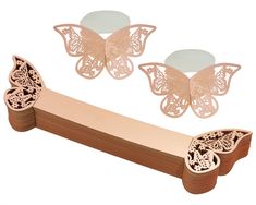 two butterfly shaped mirrors sitting on top of a wooden bench next to another piece of furniture