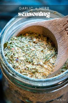 a wooden spoon in a jar filled with herbs